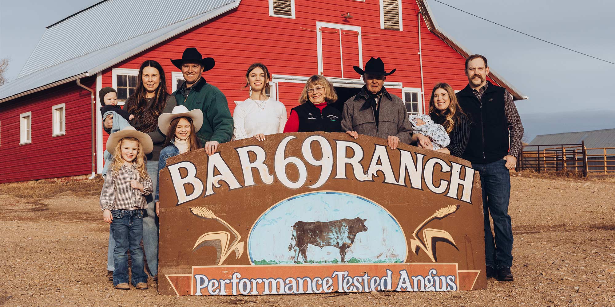 Family standing behind Bar 69 sign